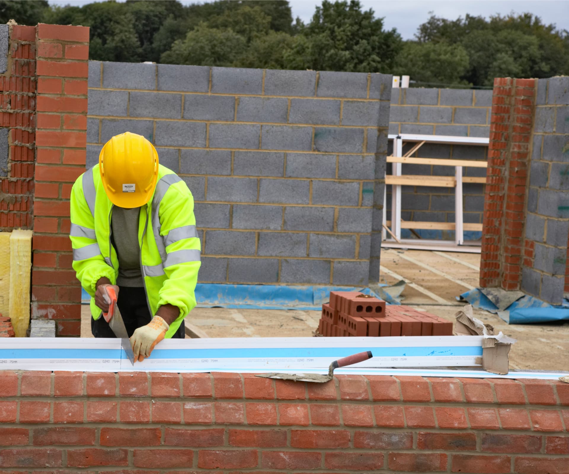 Haarth site manager reviewing plans on a UK construction site